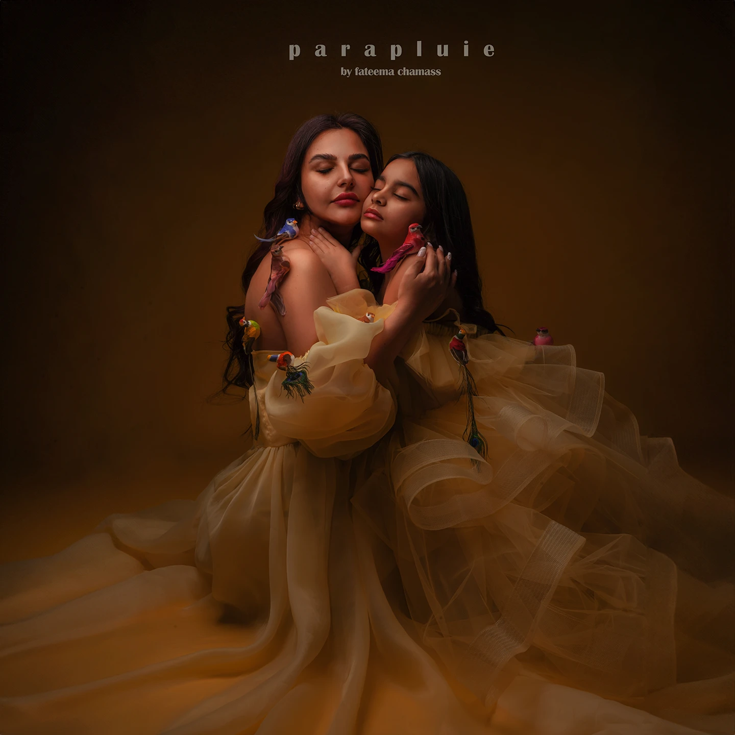 Fine art mother and daughter with yellow gowns